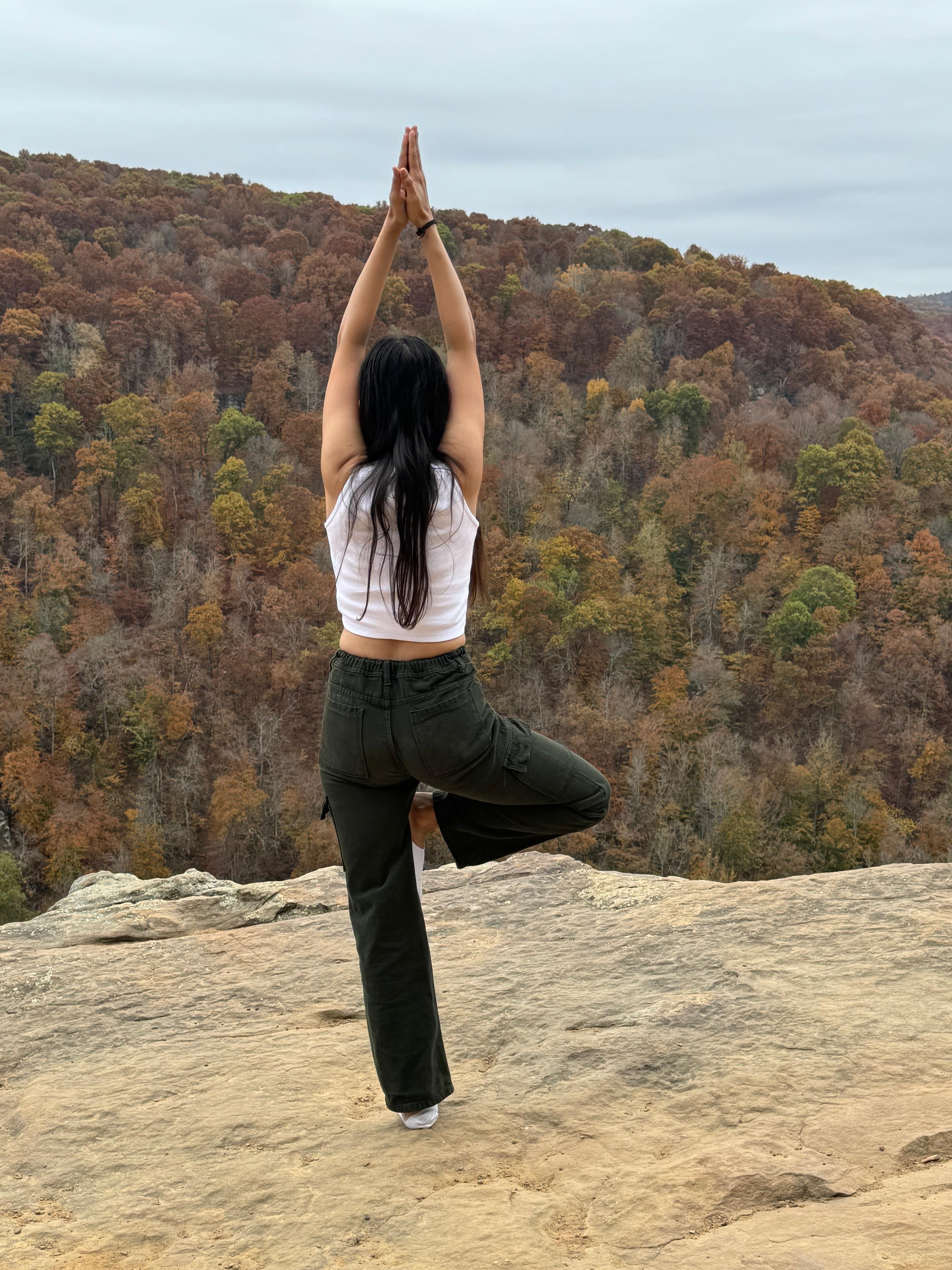 Khushbu doing a yoga pose during a trek in Central USA